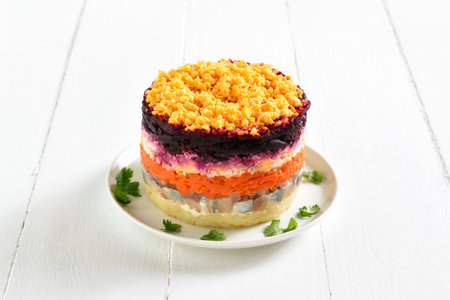 Shuba salad. Dressed herring, herring under fur coat. Christmas layered vegetable salad with herring and boiled vegetables. White wooden background, close up viewの写真素材