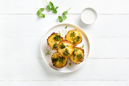 Loaded egg muffins made with eggs, bacon, broccoli, cheese on white wooden background. Diet meal for breakfast or lunch. Top view, flat layの写真素材