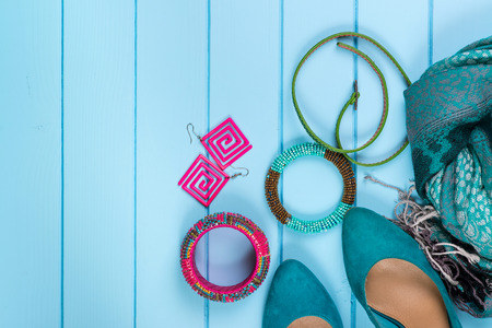 Set of fashionable women's acsessories on the blue wooden background.の写真素材