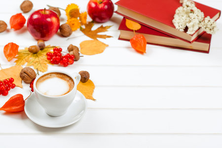 Autumn background, cup of cappuccino and books, space for text.
