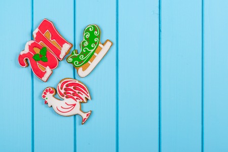 Christmas colorful gingerbread cookies on the blue wooden background. Winter holidays concept. Space for text.の写真素材
