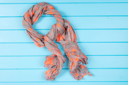 Women scarf on the wooden background. Blue wooden background.