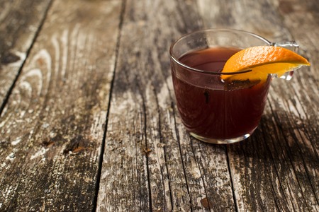 Mulled wine with spices on the wooden background. Selective focus. Space for text.の写真素材