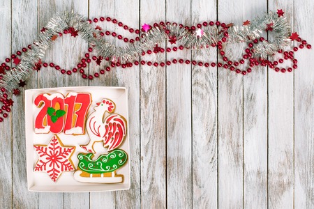 Christmas gift box with gingerbread cookies on white wooden background. Winter holidays concept. Space for text.の写真素材