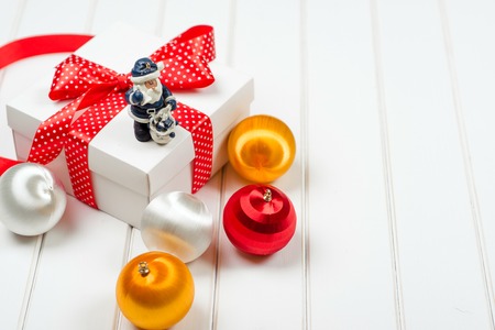 Christmas gift box on the white wooden backround. Winter holidays concept.の写真素材