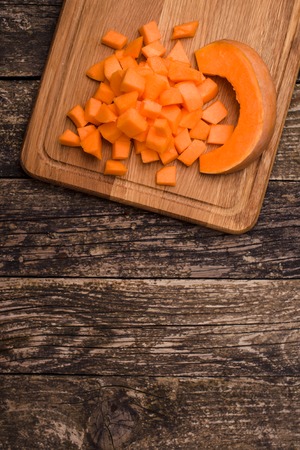 Home cooking pumpkin soup. Pieces of pumpkin on the board . Space for the text.の写真素材