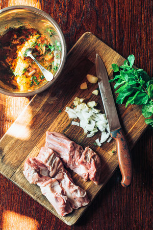 Raw fresh Lamb Meat ribs and seasonings on the wooden background.