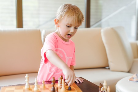 Cute little boy playing chess. Playing chess.の写真素材