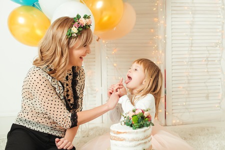 Happy mother playing with her little daughter. Birthday concept. Mother's day concept.の写真素材