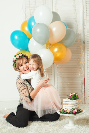 Happy mother playing with her little daughter. Birthday concept. Mother's day concept.の写真素材