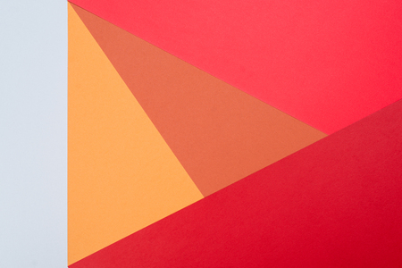 Color papers geometry flat composition background with pink,red, orange and grey tones.の写真素材
