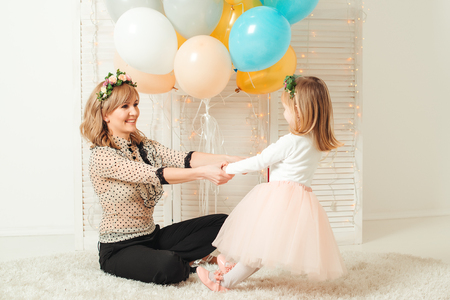 Happy mother playing with her little daughter. Birthday concept. Mother's day concept.の写真素材
