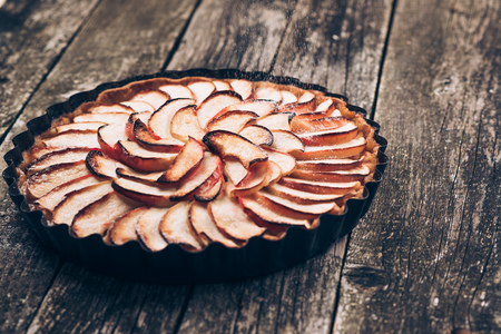 Apple pie tart on rustic wooden background. Ingredients - apples and cinnamon .Top view.の写真素材