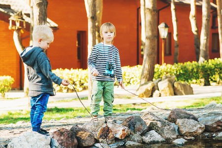 The two cute little boys playing outdoor.の写真素材
