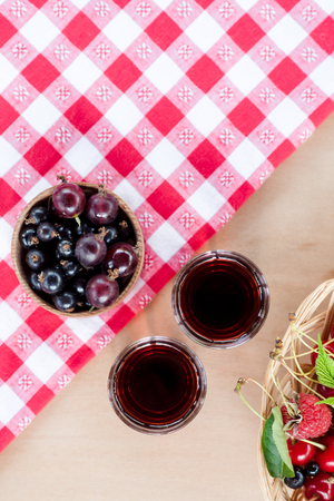 Homemade liqueur made from a black currants and red gooseberry.の写真素材