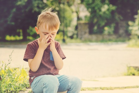 Little kid boy 4-5 years old crying on summer walk.の写真素材
