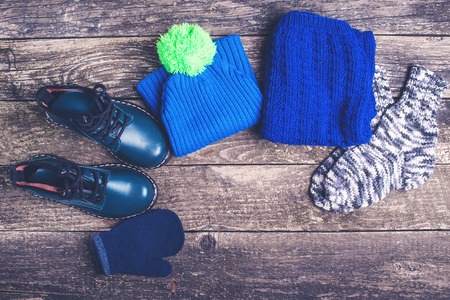 Autumn or winter outfit. Boy's fashion clothes and accessories on the wooden background.の写真素材