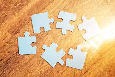 Incomplete jigsaw puzzles on the brown background, top view, flat lay. The concept of logical...