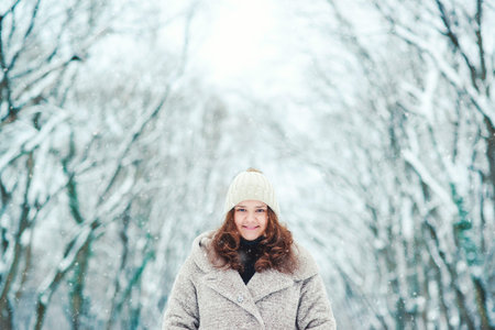 Happy young woman in a wintertime, walk in nature. Winter concept.