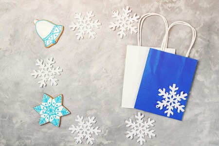 Frame from christmas decorations and shopping bags on the grey background. Christmas and winter sale concept.の写真素材