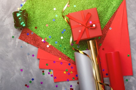Set of festive decorative paper and ribbon for wrapping gift boxes on the grey textured background.の写真素材