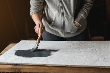 Process of coloring in dark grey color textured concrete surface for a desk.の写真素材