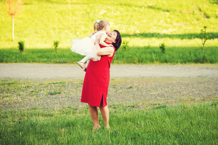 Cute little girl and young grandmother playing outdoor.の写真素材