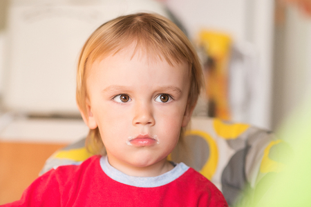 Portrait of cute little boy with dirty mouth after feeding .の写真素材