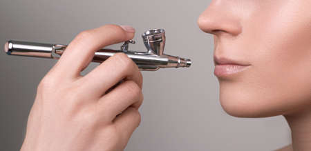 Lip protection. Make up with air brush. Young woman healthy lips. Female model mouth with nude makeup. Perfect skin care. Lips care and beauty. Beautiful woman face.の写真素材