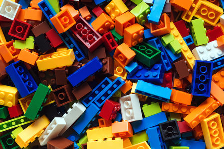 Colored toy bricks background. Lot of colorful rainbow toy bricks background. Educational toy for...