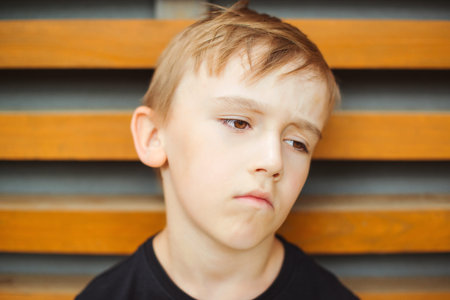 Portrait of upset gloomy boy. Kid with pessimistic depressive negative emotions. Boredom child. Face...
