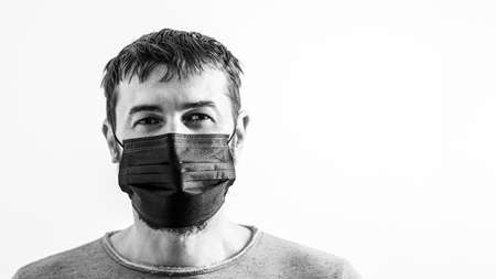 Young man in protective mask. Protection against contagious disease, coronavirus. Coronavirus epidemic. Medical and healthcare concept. Novel coronavirus. Quarantine.の写真素材
