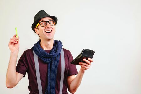 Nerd man with calculator. Accountant makes calculations. Guy has new ideas for business. Guy planning new start-up. Business, banking and education concept.の写真素材