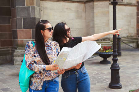 Girls travelling together and enjoying life. Summer vacation. Trip to Europe with best friend. Travel, lifestyle and people. Young happy tourists women sightseeing in city on vacation.の写真素材