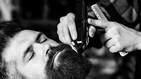Hairstylist serving client at barber shop. Vintage barbershop, business. New perfect style. Beard...