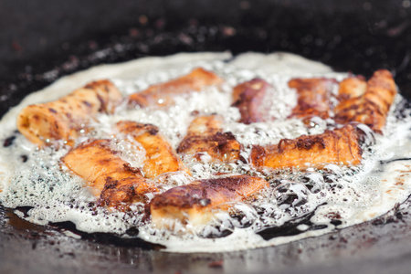Fried pies in big pan, close up. Street food. Street market. Tasty fried pies.