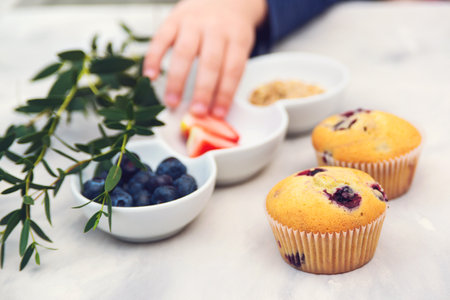 Confectioner decorating cupcakes. Cooking class, culinary and bakery. Tasty cream cheese cupcakes. Woman cooking cakes.の写真素材
