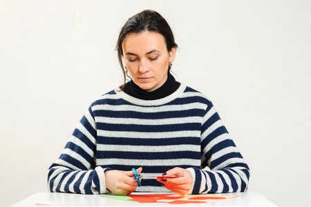 Girl makes greeting heart for Valentine's Day. DIY greeting card. Love, romantic, letters. Holiday decorations background. Valentine's day scrapbooking.の写真素材