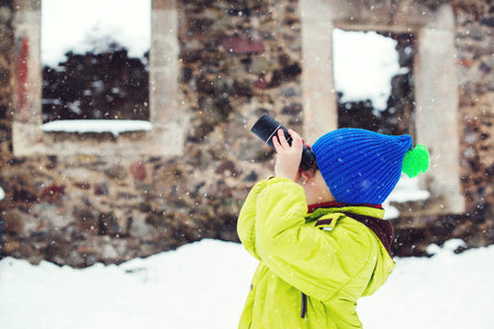 Child walking around old castle. Little boy discovery intresting things during using monocular....