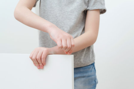 Boy assembles a bookshelf hisself. Dad and little son assembling furniture at home