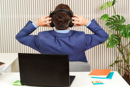 Successful businessman resting at his office. Business man finished big project. Back view office...