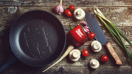 Cooking utensils and spices on wooden background, top view. Food background on dark wooden table....
