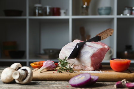 Pork meat chop with butcher knife. Cooking fresh pork ribs for roasting and cooking. Meat with bone on a wooden cutting board. Sale of meat, butcher shop.の写真素材