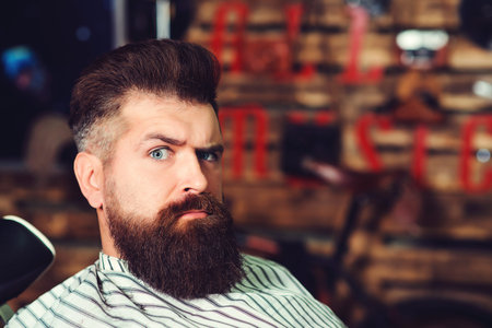 Bearded man at barber shop. Men hairstyle, beard and mustache. Fashion and male beauty. Brutal...