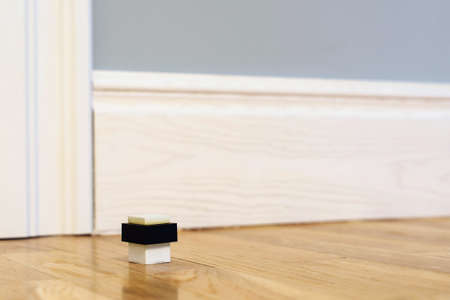 Modern door stop on the floor. The door stopper. Modern door stop on the floor. The door stopper. Close-up elements of the interior of the apartment.の写真素材