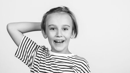 Portrait of funny boy. Kid having fun and laughing. Children style and fashion. Happy boy with stylish hairstyle. Happy childhood and positive emotions. Face expression. Smiling boy posing at studio.の写真素材