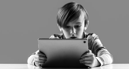 Online school, modern technology. Children, technology and education concept. Shocked school boy...