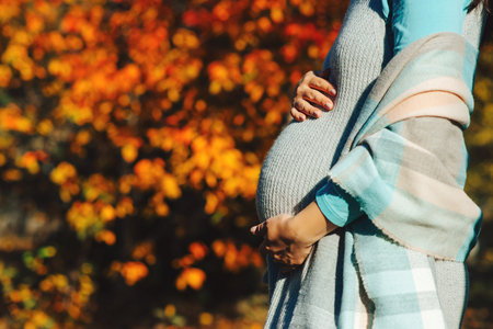 Pregnant woman in touching big belly with hands. baby expectation. Pregnant woman outdoors in...