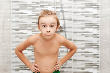 Cute child washing himself in shower. Happy boy having a shower in bathroom. Healthy childhood, lifestyle concept.の写真素材