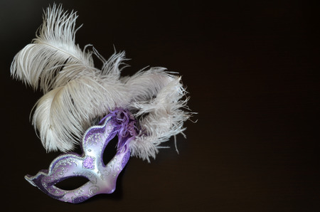 Venetian mask with feathers on a dark backgroundの写真素材